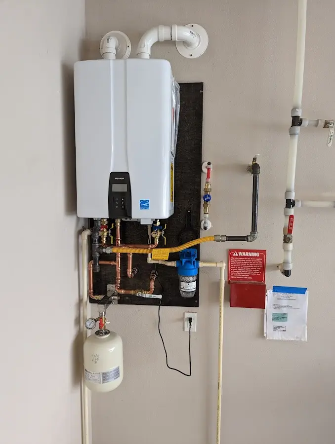 Professional plumber installing copper piping in a Bowie home
